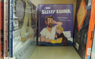 Becks first book, The Sleepy Reader, sits on the children book shelf in the North library. Becks book was published Sept. 4, 2018.