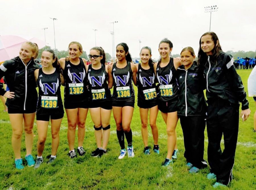 The PNH girls cross country team poses for a picture while they wait to begin their race. “I’m pretty used to winning. It definitely wasn’t like that in the beginning. I remember the first year or two, when I started running, I got last place in everything,” said freshman Tabitha Bevans.