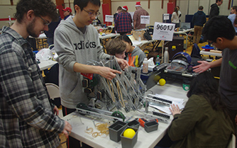 Seniors Joshua Monsey, Jeremy Lau, Jerod Peterson, Yona Liu, Jessica Goldberg, and Joshua Prila make adjustments to their robot in between matches. “Being on the robotics team is a pretty big commitment and our students take robotics as serious as any team sport.” said sponsor Brandon Franck.