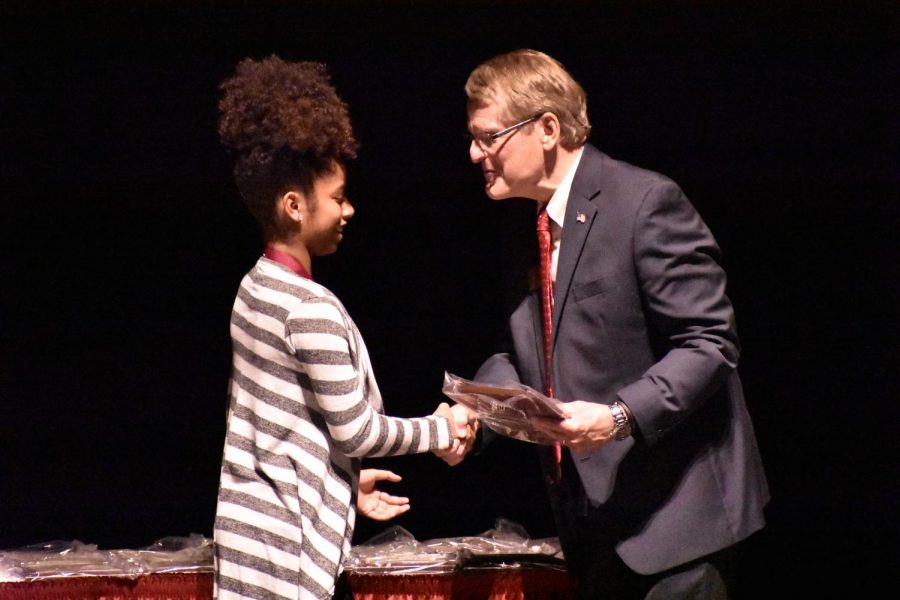 Sophomore Ciara Thomas receives the Spirit of Excellence award from Dr. Keith Marty. High school students who receive the award have a cumulative GPA of 3.5 or higher. “I was really happy [to receive the award] and was pleased to have the experience of being there,” said Thomas.
