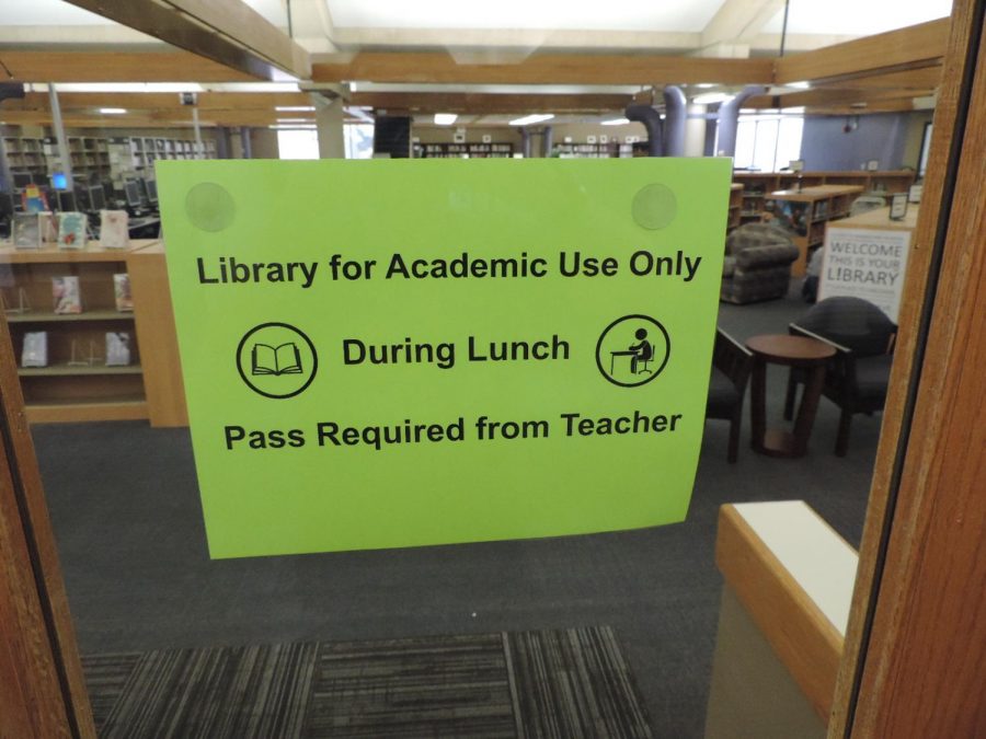 This sign located on the library doors sends a confusing message to students regarding their access to library resources. Students are able to use the library during lunch for academic purposes.