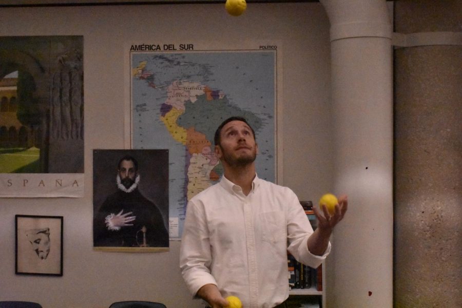 Latin and English teacher Adam Stiller juggles yellow tennis balls in his classroom. The juggling club meets every Tuesday in room 1500.