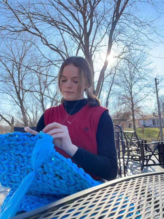 Natalie Arnold crochets used plastic bags together to make one of the many mats she plans to donate to help people the homeless.