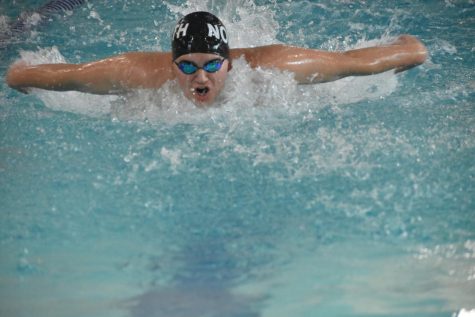Freshman Tanner Huelsmann swims the 100 meter fly at state where he got his personal best. His brother senior Riley Huelsmann beat the schools 30 year record for the 100 meter breaststroke the same day.