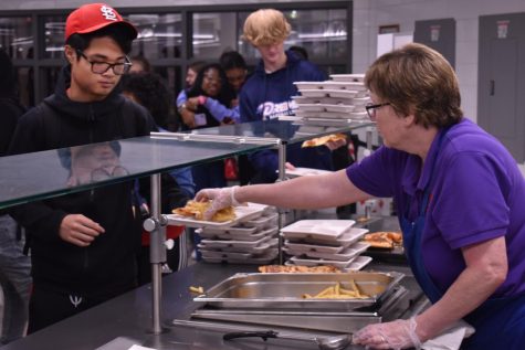 Freshman Cooper Hough orders a pizza from the 2mato line during lunch. Pizza is the most popular choice among students.