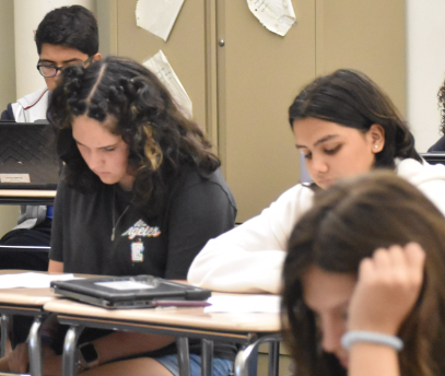 Rereading her work, freshman Ada Balko sits in English class. “I like how relaxed the teachers are, Balko said. I feel like I can be myself and work in my own way without getting in trouble.”