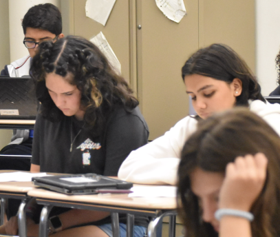 Rereading her work, freshman Ada Balko sits in English class. “I like how relaxed the teachers are," Balko said. "I feel like I can be myself and work in my own way without getting in trouble.”