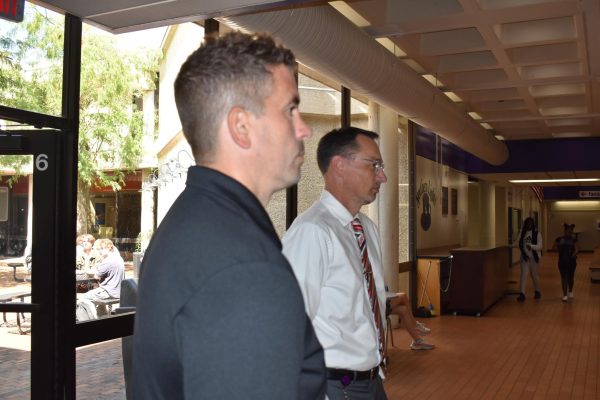Athletics director Josh Martin and principal Chris Gray monitor the commons during lunch. The commons serves as a nexus point for travel, needing special surveying.