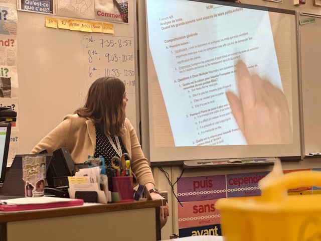 French teacher Suzanne Johnson goes through French AP-style multiple choice answers with the class in both French and English. Being the only French teacher makes it difficult for her to balance preparing for classes and wanting to sponsor French club.