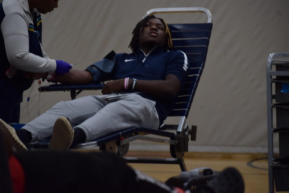 Senior Jayden Hall looks away as the nurse draws his blood. Its not unusual for people to be nervous about blood. About a quarter of the adult population has some discomfort with the concept.