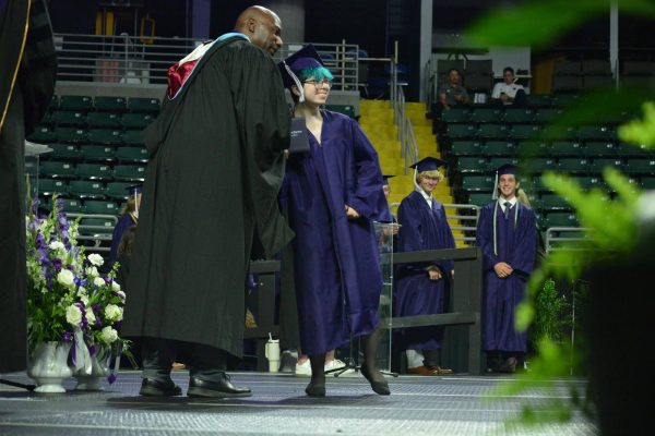 At senior graduation, Mr. Jones hands senior Jessica Byrd their high school diploma, signifying an end to her high school education and the start of her next chapter.