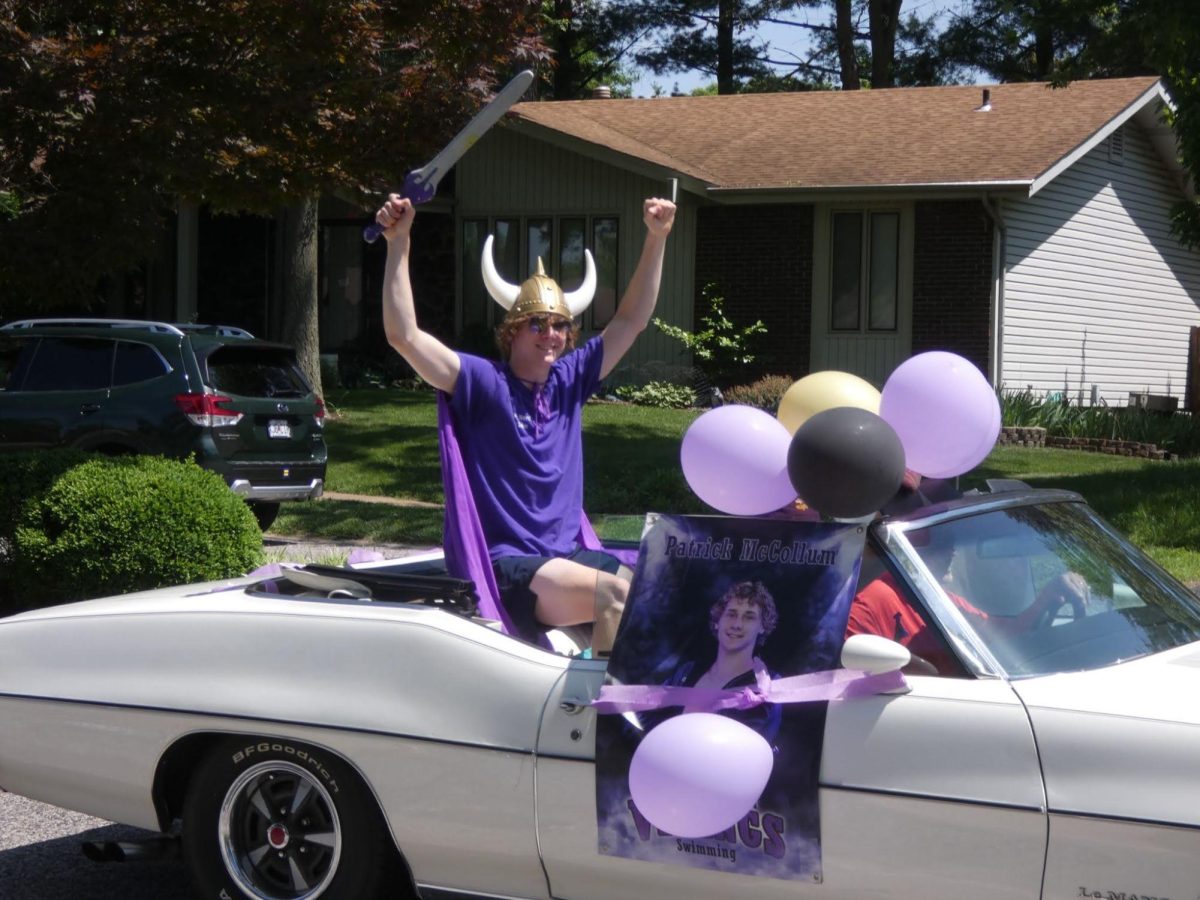 Decked out in his Viking gear, senior Patrick McCollum rides through the parade. McCollum was captain of varsity water polo and varsity swim; he also tookseeral AP courses. 
