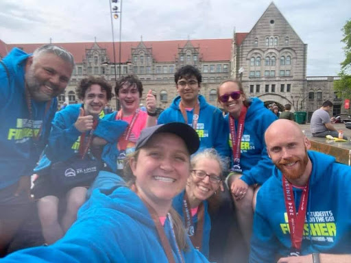 A group of students and staff gather for a selfie after the race.  During actual runs, I was usually nowhere near friends. Running becomes pretty lonesome after the first mile, especially when youre a slower or faster runner. Most running-related social interactions happen before and after runs, júnior Eric Lipsutz said.