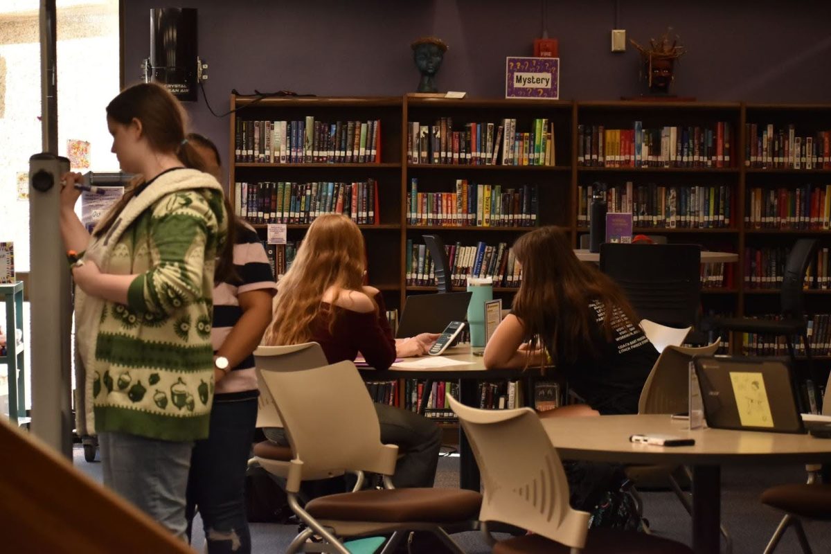 A tutor helps a fellow student in the library on Tuesday after school at Parkway North High. Student tutors are available Monday-Thursday after school for anyone who needs help.