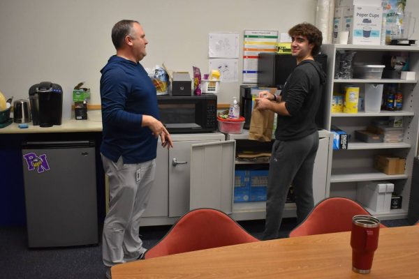 Russell Vincent and senior Max Peck discuss supplies for the Northern Lights Cafe. The Northern Lights Cafe opened on Sept. 18, bringing a few new changes due to safety regulations and construction