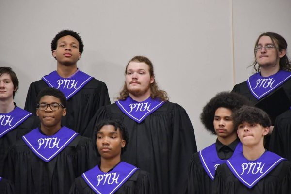 Baritones and tenors prepare for the concert to begin. Roback started off with a speech describing what the concert was going to do, then ushered the group to the risers. 