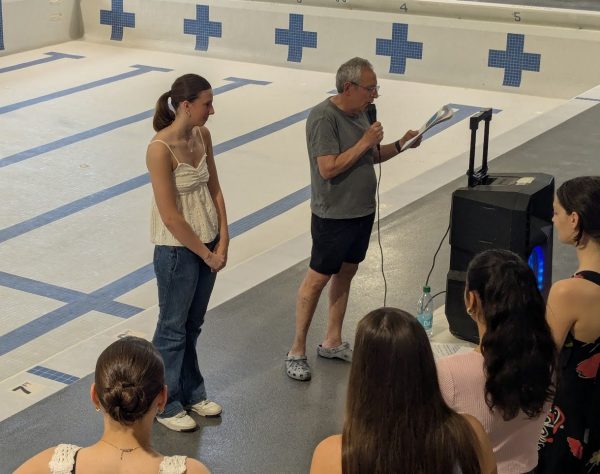 At the Water Polo and Swim Senior Night on Tuesday, May 6, water polo coach Norman Rich reads senior Athena DeKinder’s bio. The Senior Night was held on the deck of North’s pool, but without many of the traditions usually included in water sports’ Senior Nights.