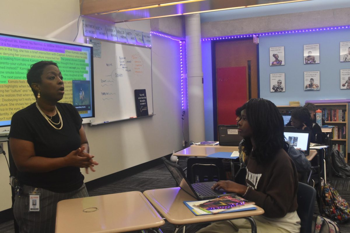 Freshman class administrative assistant Ms. Webb shares advice with freshman Anny Byamungu about where new students can find support if they need guidance or have questions to ask. Anny was one of many students learning from Ms. Webb during a recent visit to Mr. Roy's English class.